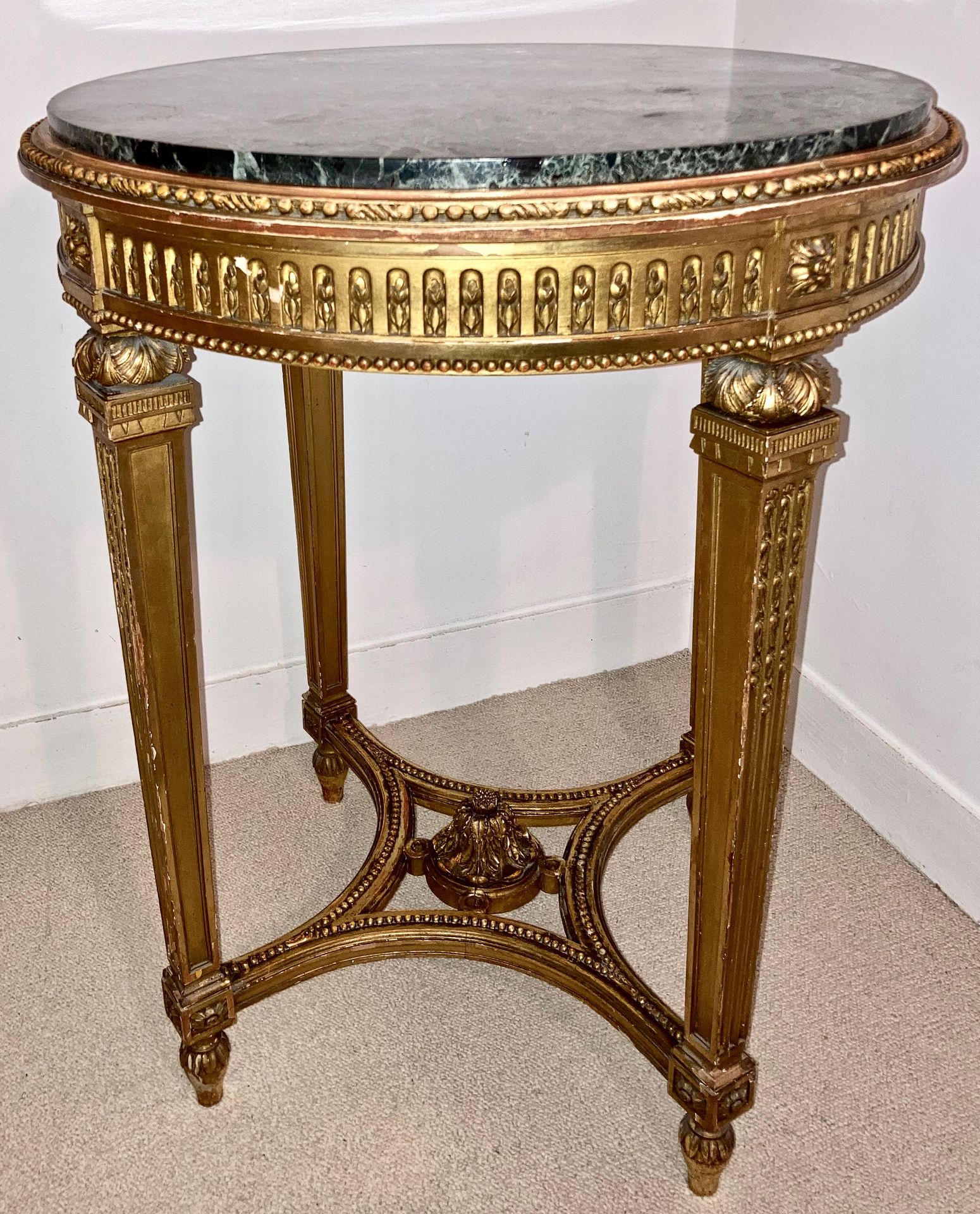 Guéridon de style Louis XVI en bois doré sculpté à décor perlé, reposant sur 4 m&hellip;