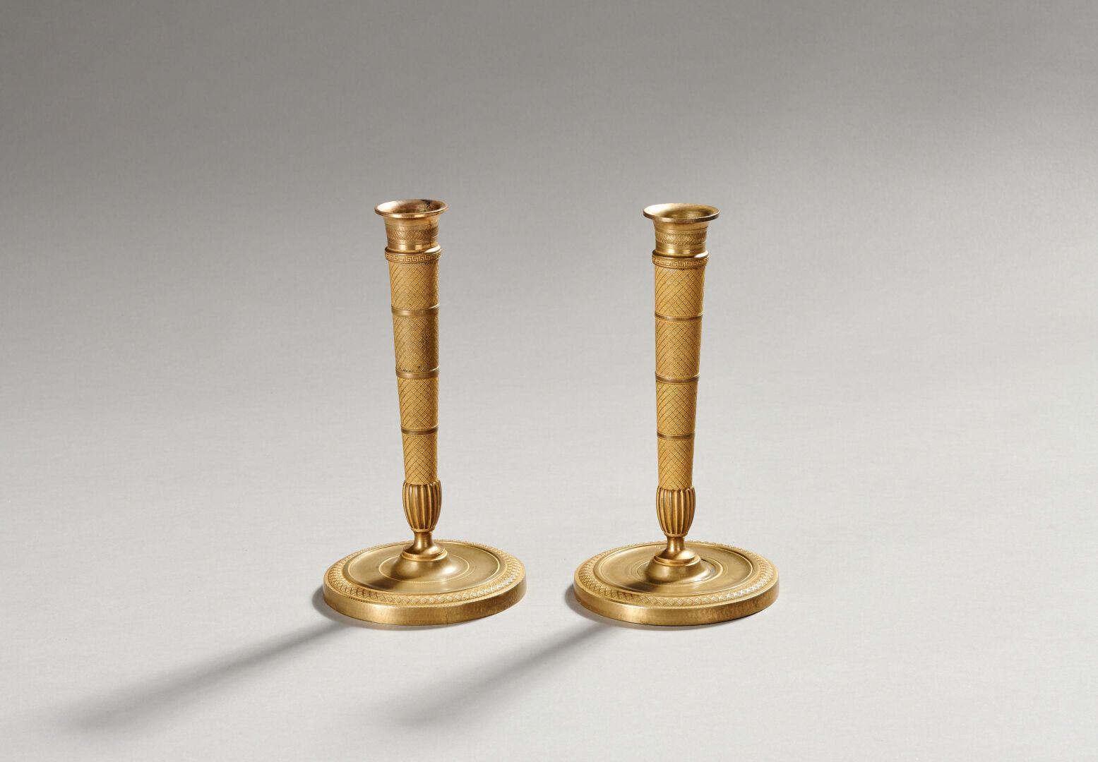 Null Pair of candlesticks in gilt bronze and chased.
The shaft decorated with st&hellip;