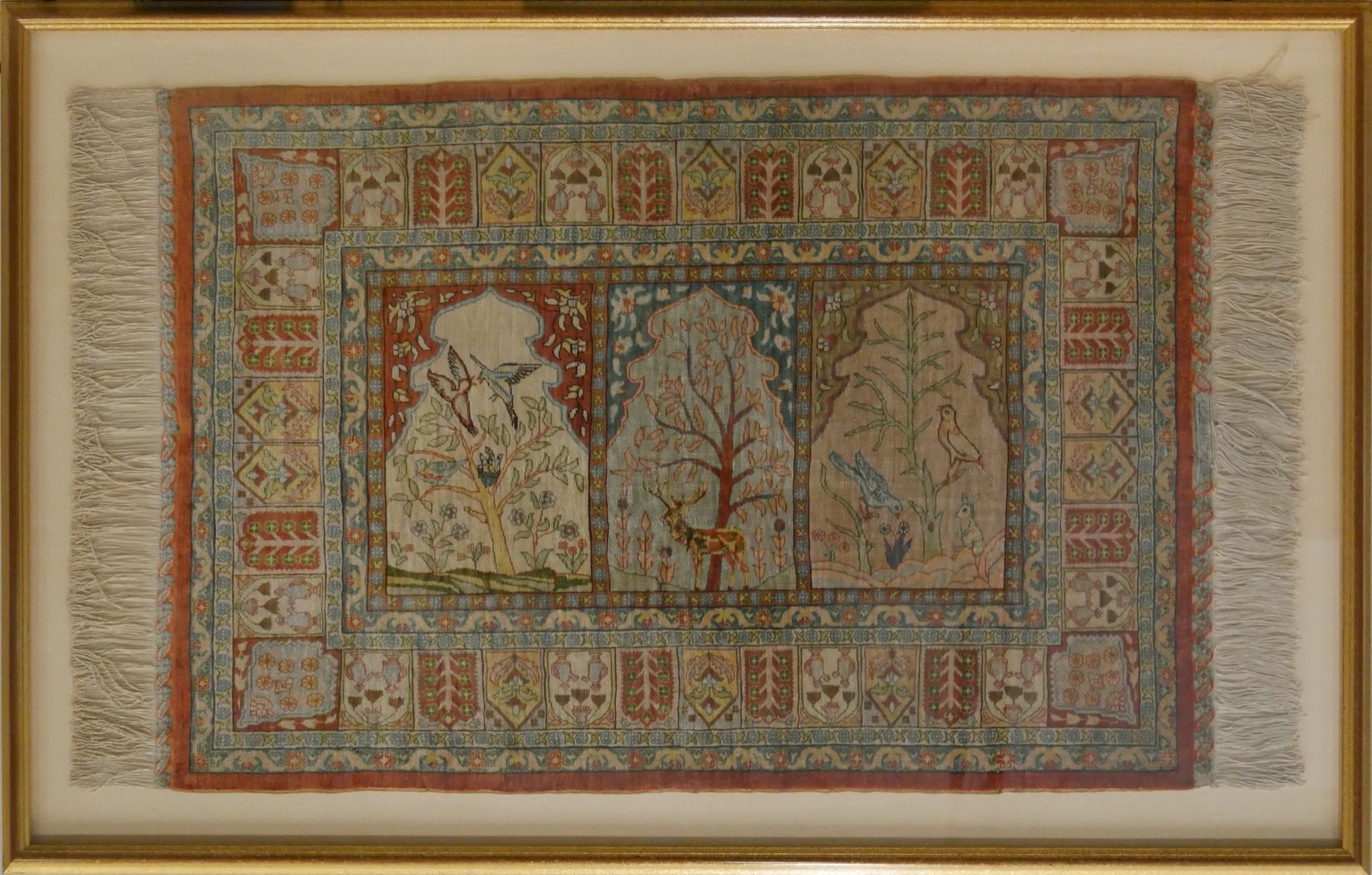 Null ANATOLIA祈祷毯，带框丝绸，20世纪下半叶

田野上有 "saf "装饰，由三个mihrabs组成，中央是一只鹿，两边是鸟和一只兔子

在边框中&hellip;