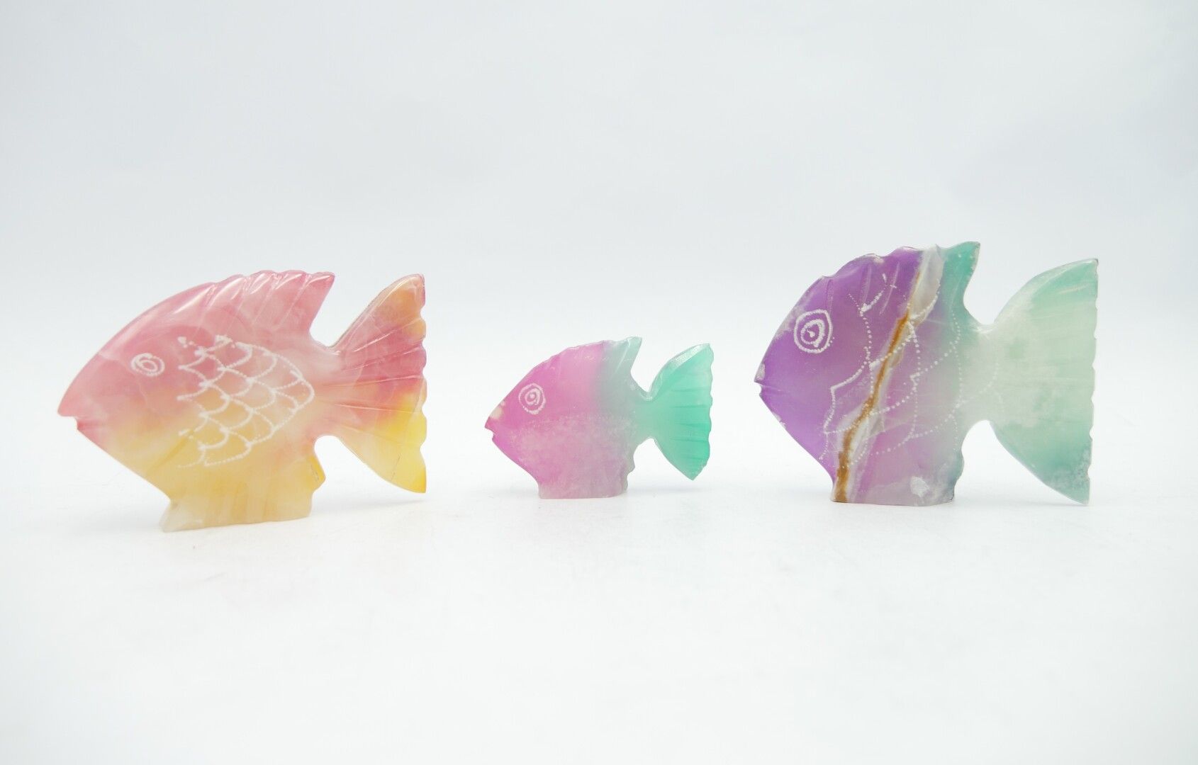 Null 20th CENTURY 

Three pink, yellow, green and violet hardstone fish 

L. Of &hellip;