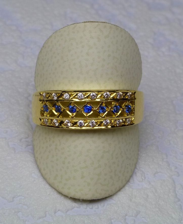 Null 镂空黄金戒指，在钻石菱形中镶嵌七颗美丽的蓝宝石，边上是两行16颗钻石 重量：4.45克