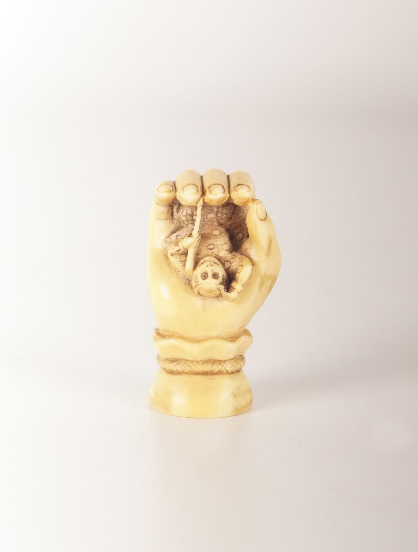 Netsuke - Japon Netsuke en forme de main tenant un singe dans la paume.. 4.9 cm.
