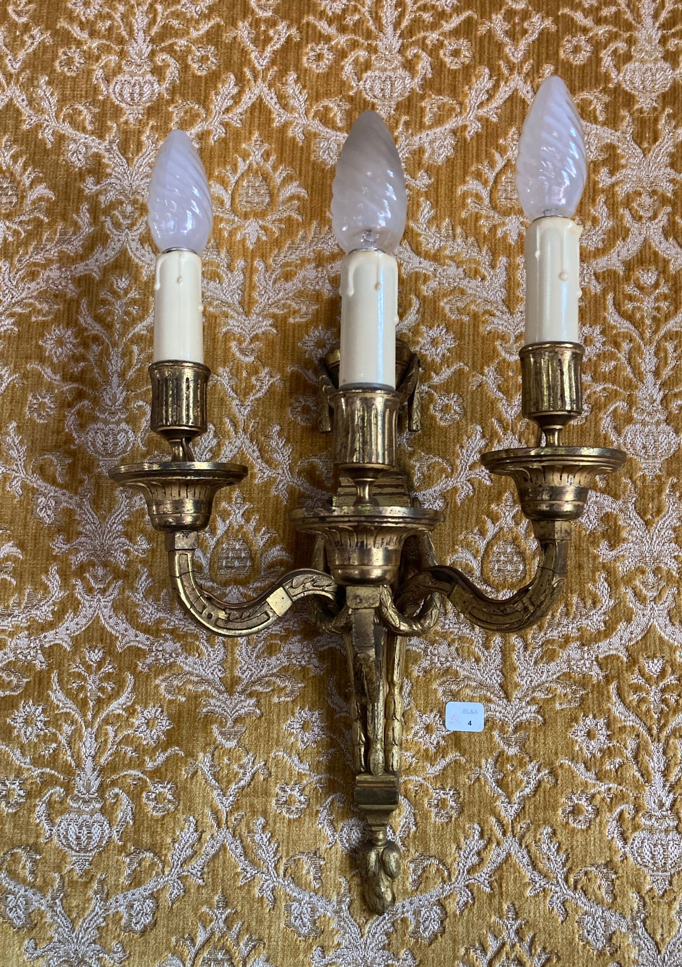 Null 4. Pair of three-light gilt bronze sconces decorated with falling laurel le&hellip;