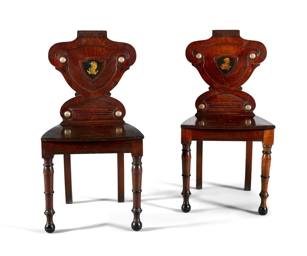 Null A PAIR OF GEORGE IV MAHOGANY HALL CHAIRS, the shield panel backs decorated &hellip;