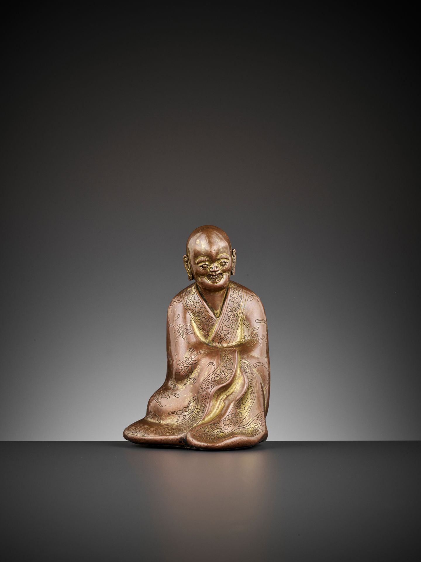 A GILT COPPER ALLOY FIGURE OF A LUOHAN, 17TH CENTURY A GILT COPPER ALLOY FIGURE &hellip;
