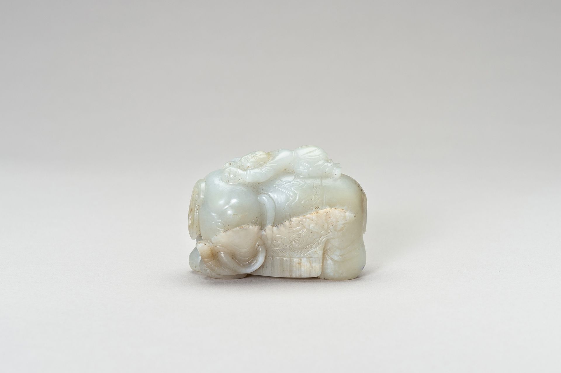 A PALE CELADON JADE CARVING OF AN ELEPHANT AND BOY ÉLÉPHANT ET GARÇON EN JADE CÉ&hellip;