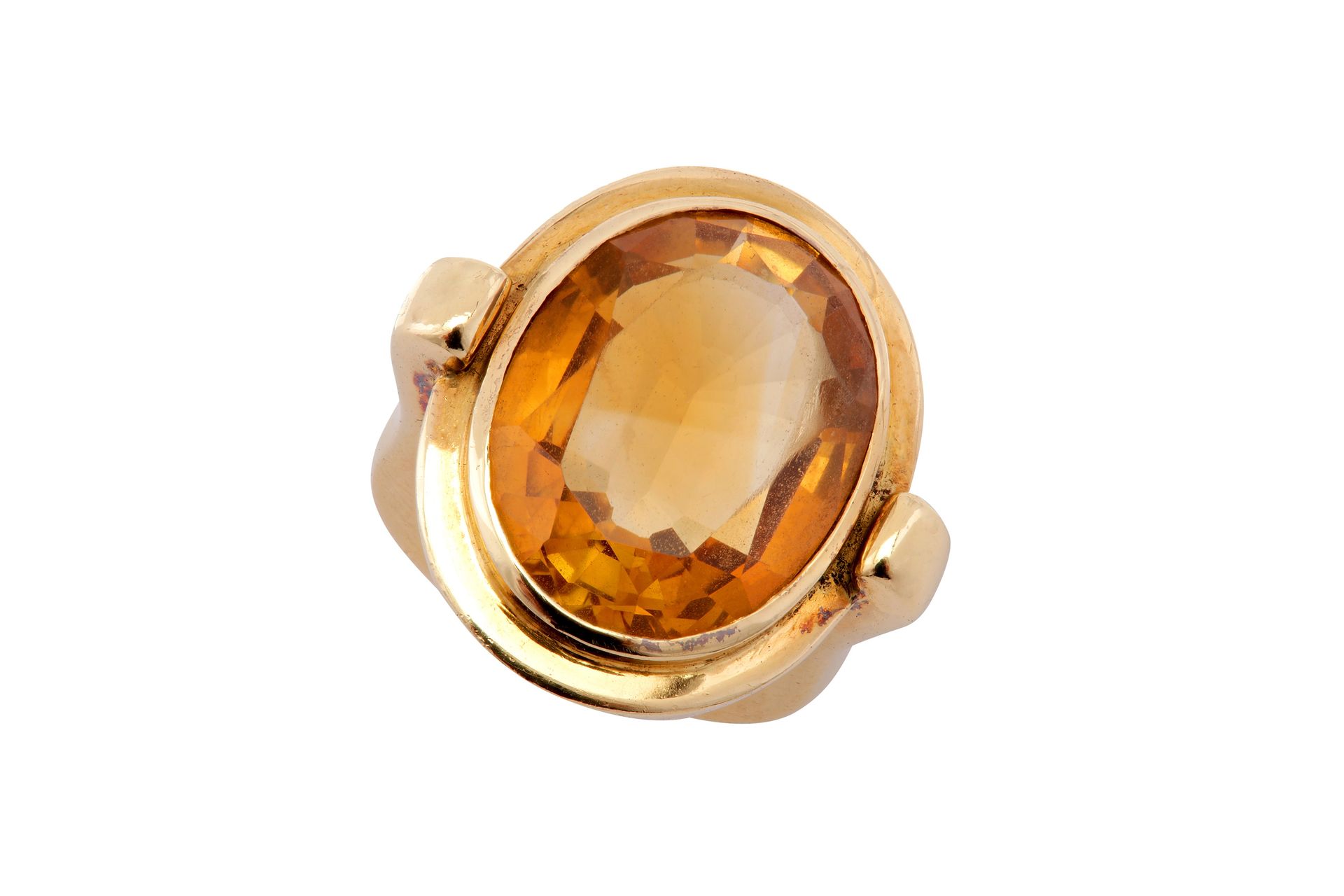 A gold citrine ring A gold citrine ring The collet-set oval-cut citrine, to a 18&hellip;