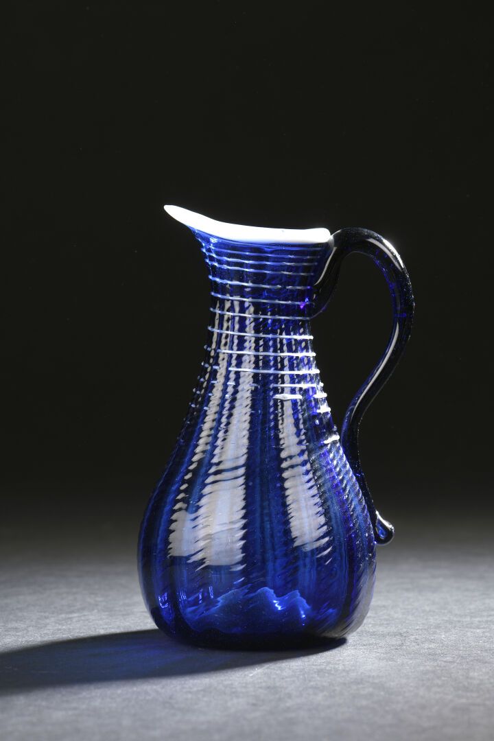 Null Blue tinted glass pitcher, Normandy, 18th century
H. 15 cm