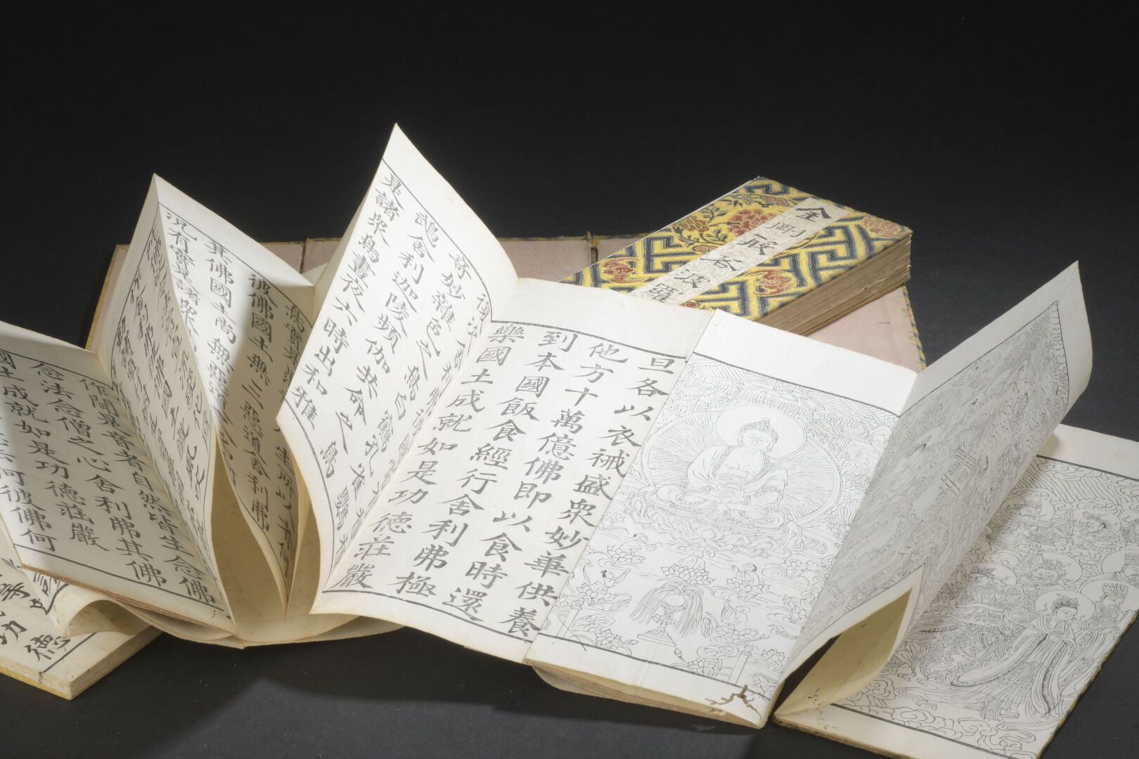 Null 金刚经和阿弥陀佛经
中国，19世纪
封面用丝织品修饰，背景是卍字形的花和蝙蝠的徽章；磨损、撕裂、污损和小虫孔。