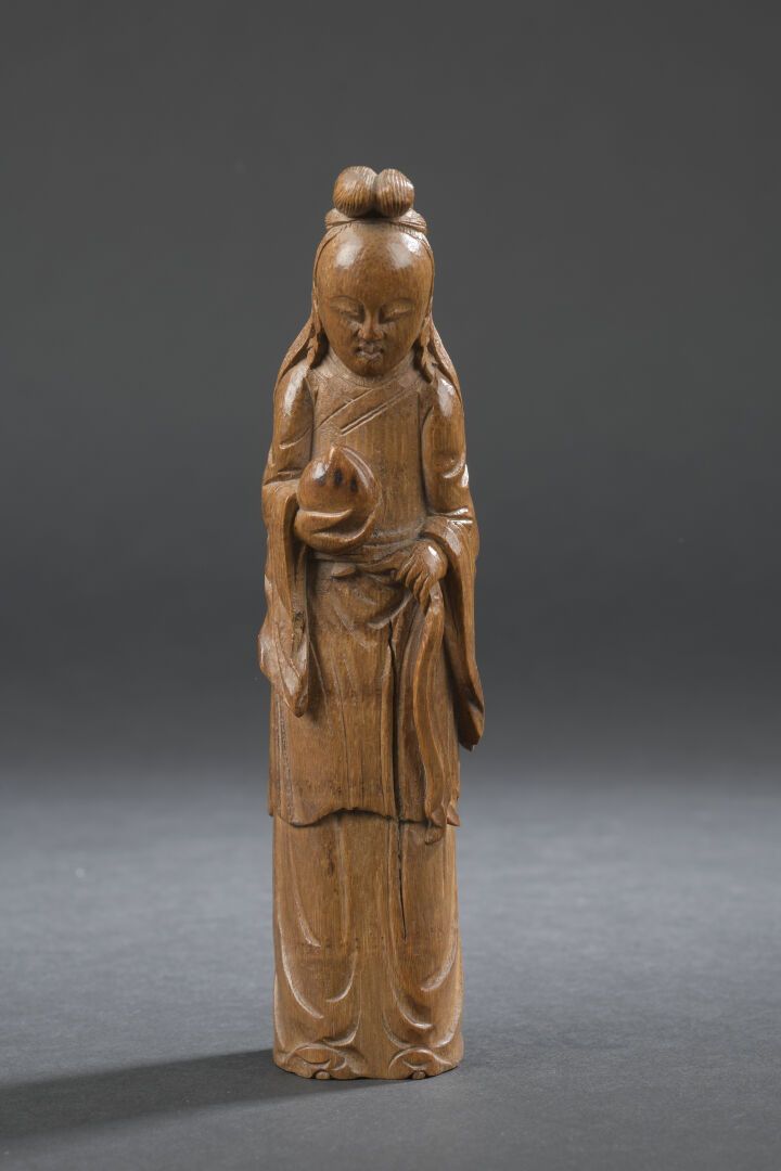 Null 雕刻的竹制玛瑙雕像
中国，清末（1644-1911）。
站立，手持桃子，身穿长裙，面带微笑，头发梳成发髻；有裂纹。
H.17.7厘米