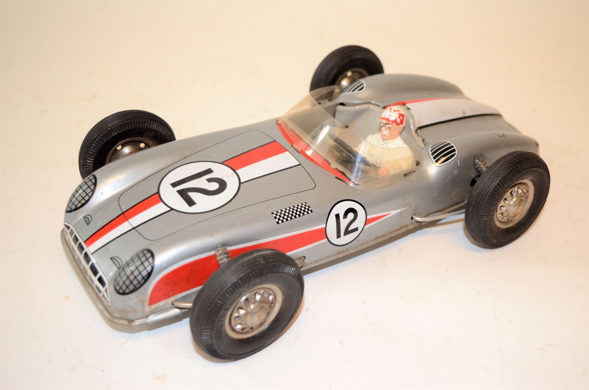 Null JOUSTRA: Racing car N°12, with friction in sheet metal. L: 28 cm. Traces of&hellip;
