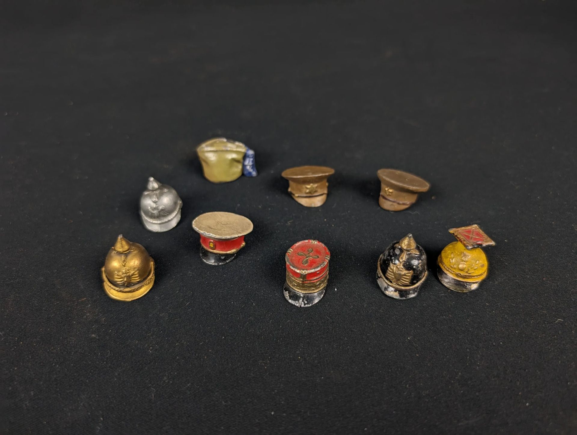 Null Lot of various WWI miniature headgear including spiked helmet, cap and misc&hellip;