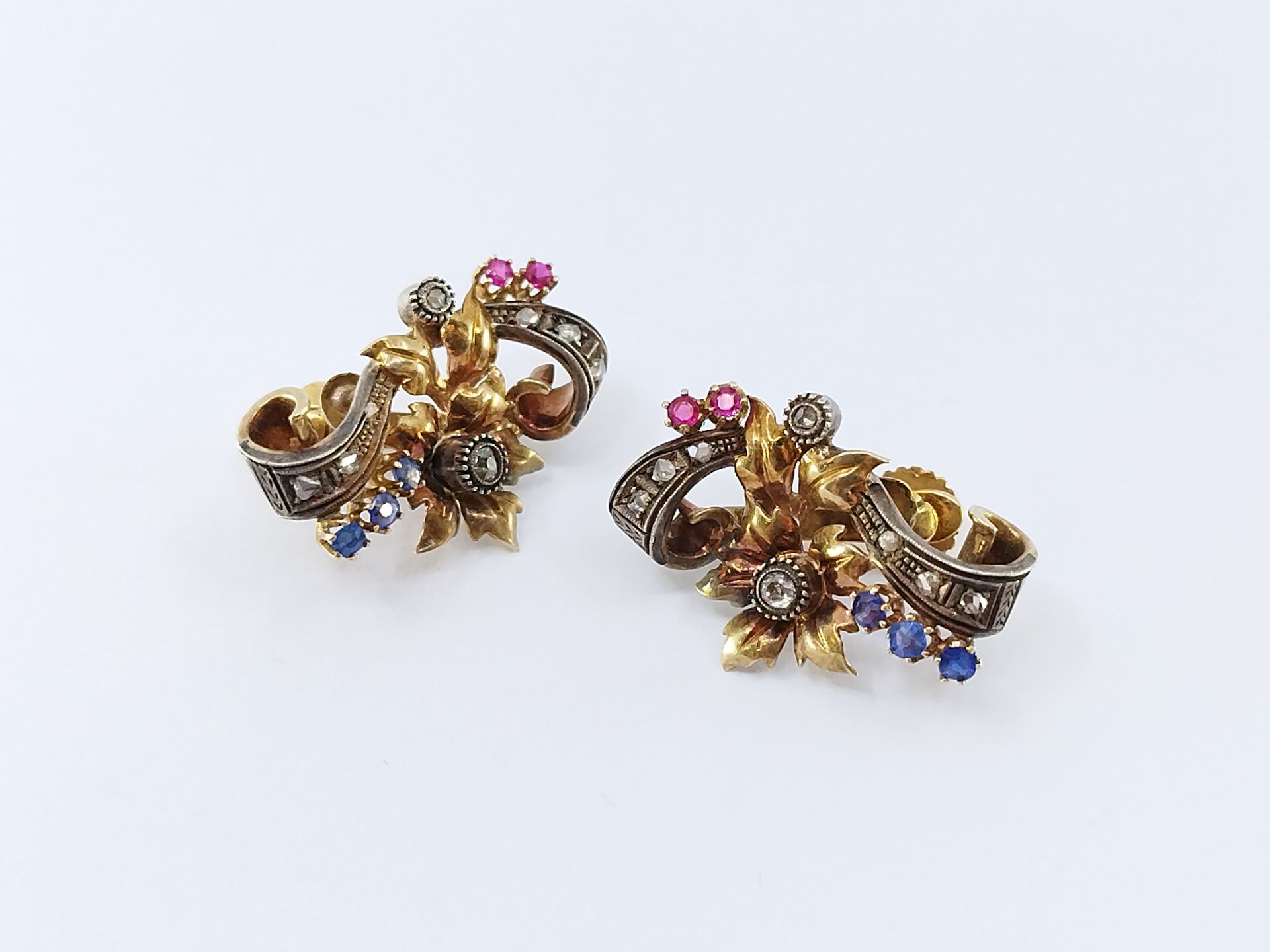 Null 一对金银色的卷轴形式的耳环，镶嵌着玫瑰和老式切割钻石，采用封闭式镶嵌。 

毛重 : 9,08 g 

约1880年

焊接的痕迹