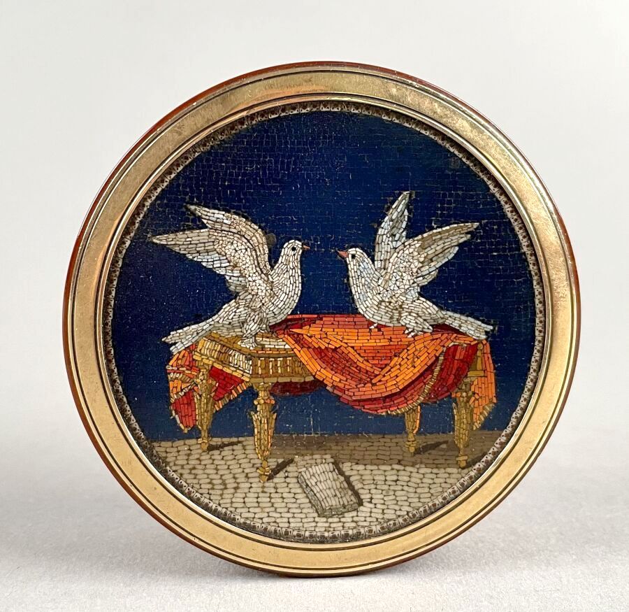 Null 金色玳瑁的圆盒，盒盖上有微细的马赛克图案，上面有两只鸽子在一张垂下的桌子上。
19世纪初。
(轻微震荡。)
直径：7.2厘米 

出处：Jacques&hellip;