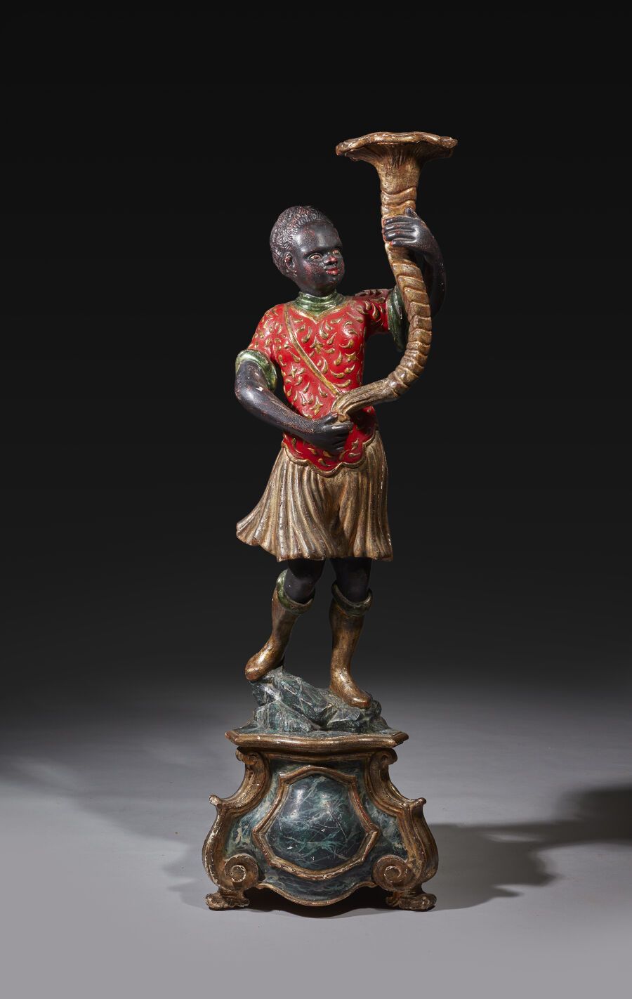 Null Figure of a Nubian torchbearer in polychrome wood and gold, holding a cornu&hellip;
