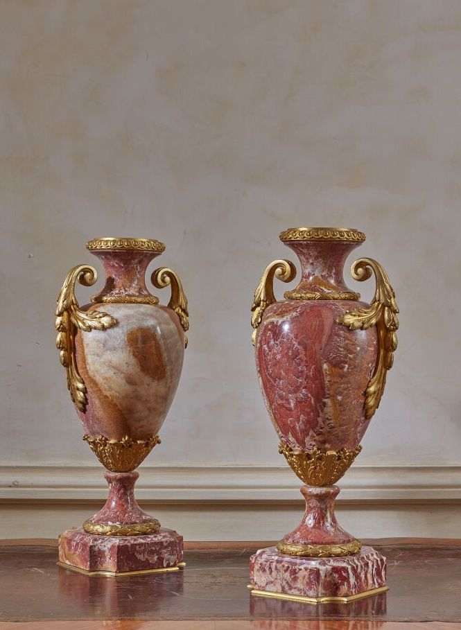 Null 一对红色脉络的大理石柱状花瓶，镀金的铜框上装饰着小圆点和树叶。 
路易十六风格的作品。
高度：38厘米。高度：38厘米