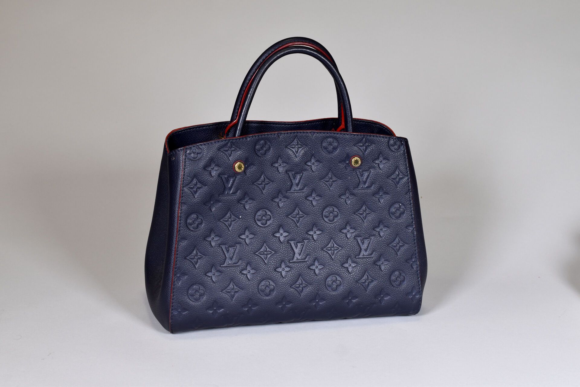 Null LOUIS VUITTON. Montaigne" model handbag in navy leather with red trim. Very&hellip;