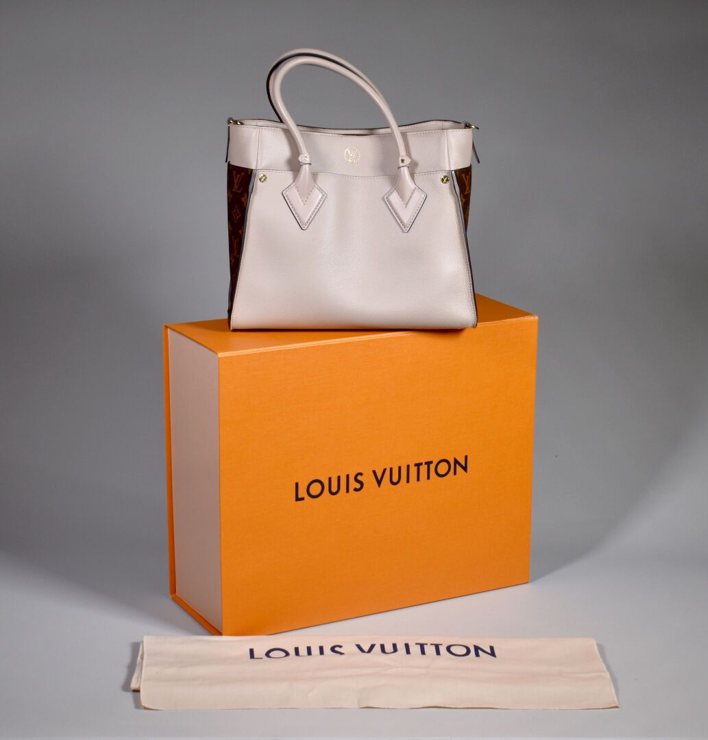 Null LOUIS VUITTON. On My Side" model handbag in coated monogram canvas and beig&hellip;