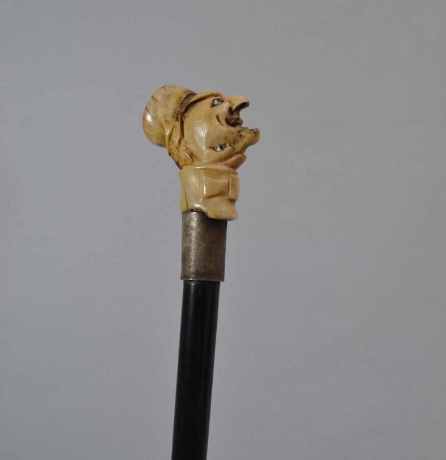 Null Blackened wood cane, the pommel in carved ivory showing a curious double he&hellip;