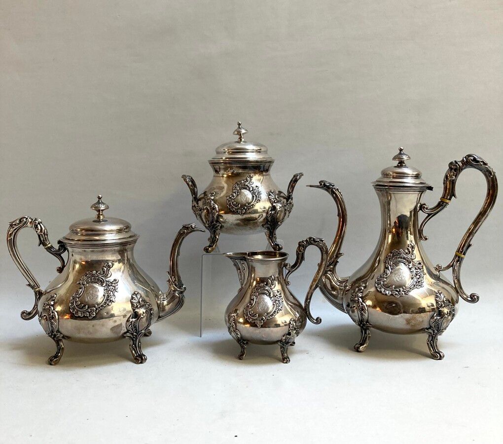 Null A silver COFFEE SERVICE resting on four feet with leafy attachments, figure&hellip;