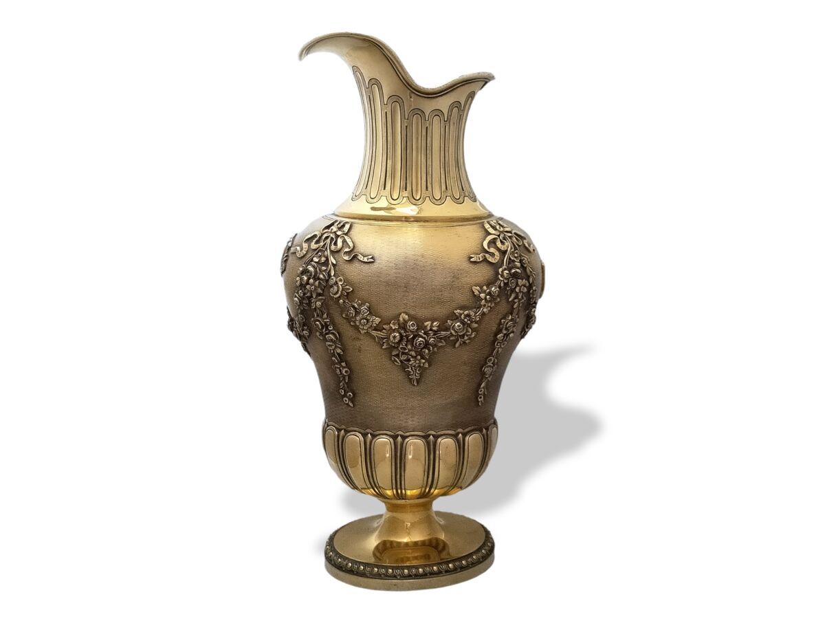 Null A vermeil ewer resting on a pedestal with a rich decoration of ovals, gadro&hellip;