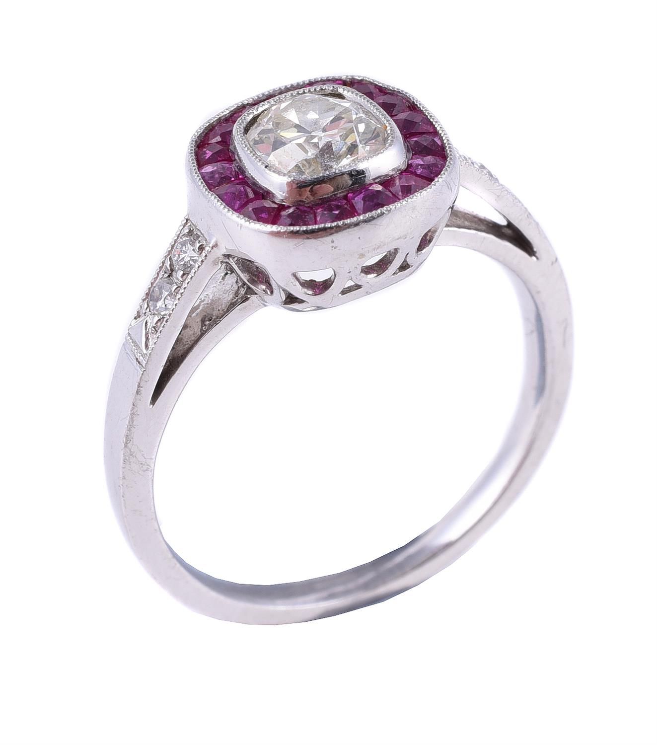 A diamond and ruby cluster ring 一枚钻石和红宝石戒指，中央为枕形切割钻石，估计重0.65克拉，周围为校准切割红宝石，印有pt95&hellip;