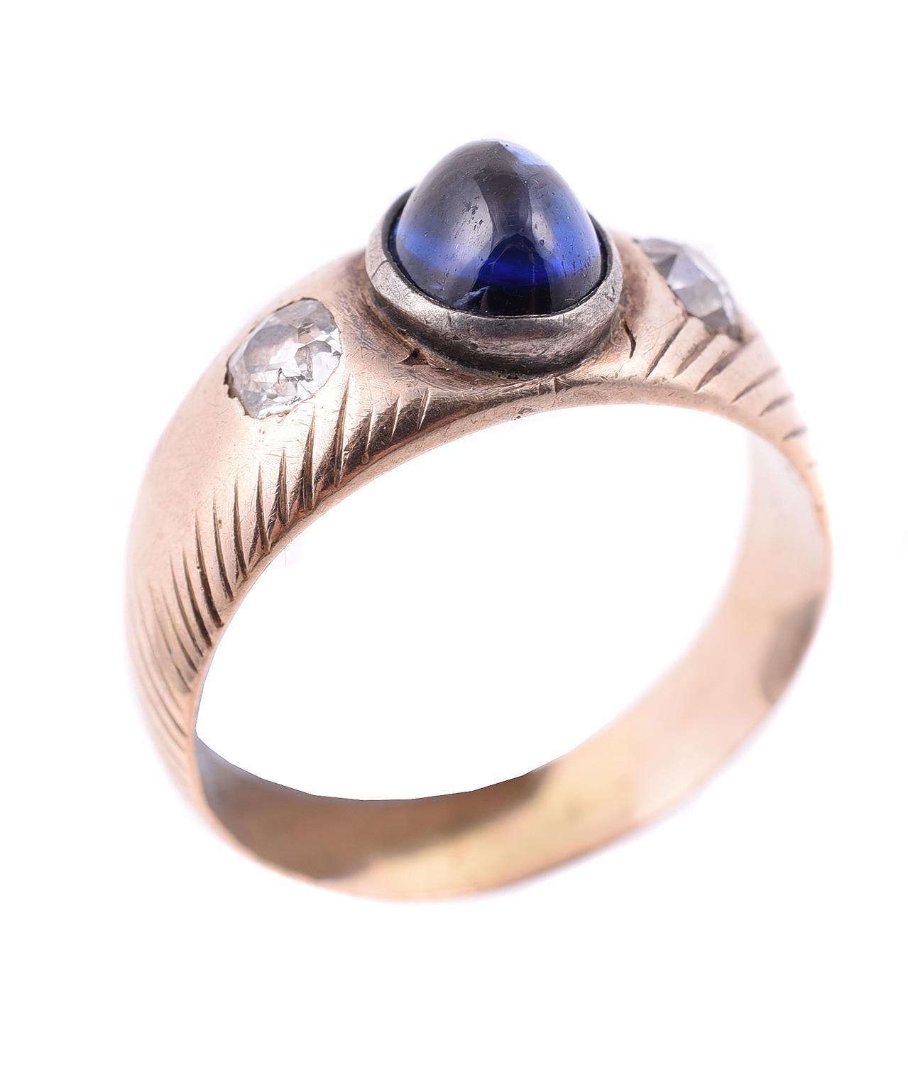 A sapphire and diamond three stone ring 一枚蓝宝石和钻石的三石戒指，中央的椭圆形凸圆形蓝宝石，两边是一对擦肩而过的老矿切&hellip;