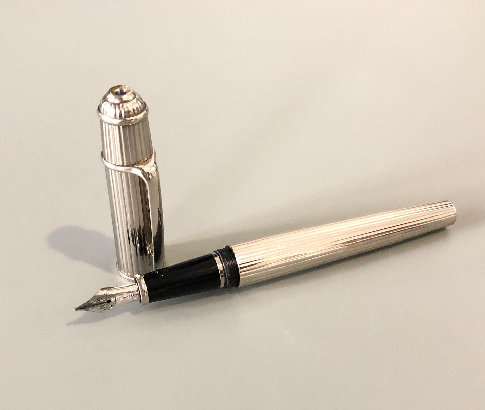 Null CARTIER - Steel fountain pen with gadroons. White gold nib. Signed Cartier.