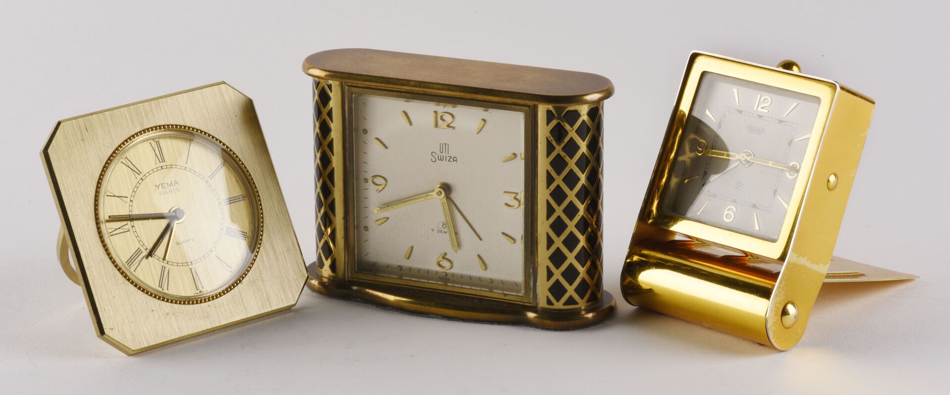 Null Set of three travel alarm clocks: 

- YEMA alarm clock in gilt brass on qua&hellip;