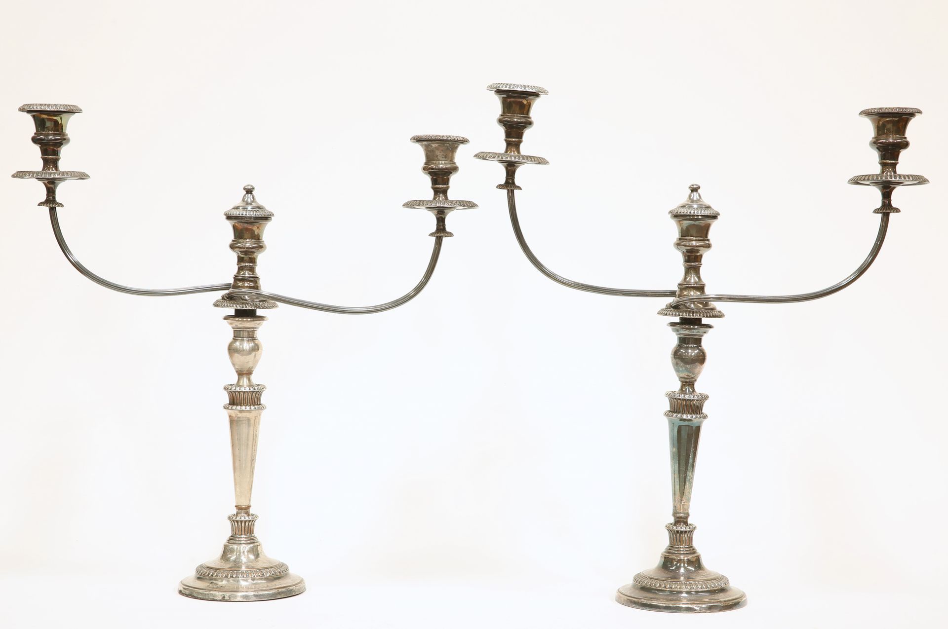 Null A PAIR OF OLD SHEFFIELD PLATE CANDELABRA, each with twin reeded scrolling b&hellip;