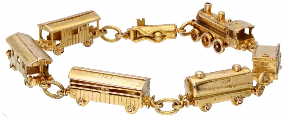 18K. Yellow gold bracelet with locomotive and 5 wagons. 带安全夹。印记：Industria Argent&hellip;