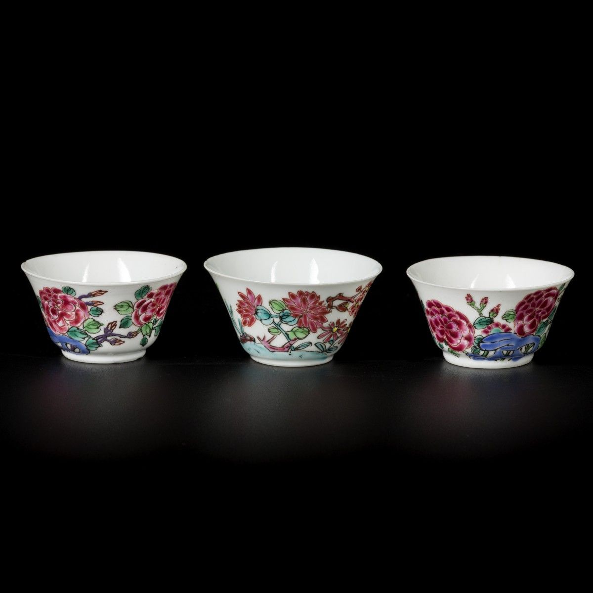 A lot comprising (3) porcelain famille rose cups with butterfly and bird decor, &hellip;