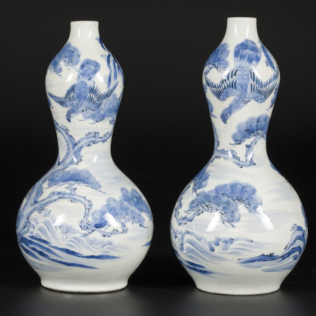 A set of (2) porcelain gourd vases decorated with falcons in a landscape, Japan,&hellip;