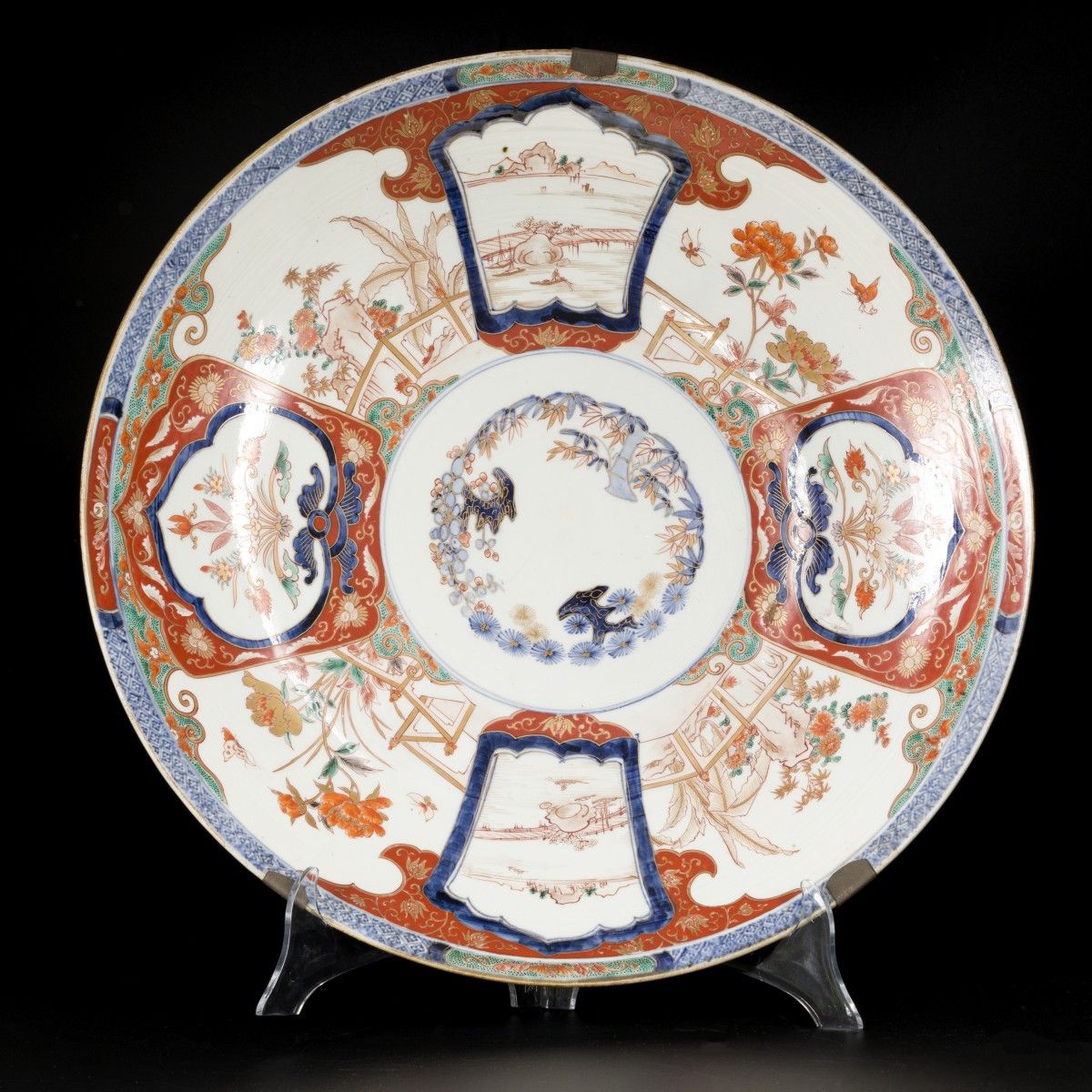 A large Imari dish with floral decoration and landscapes on the outside. Japan, &hellip;