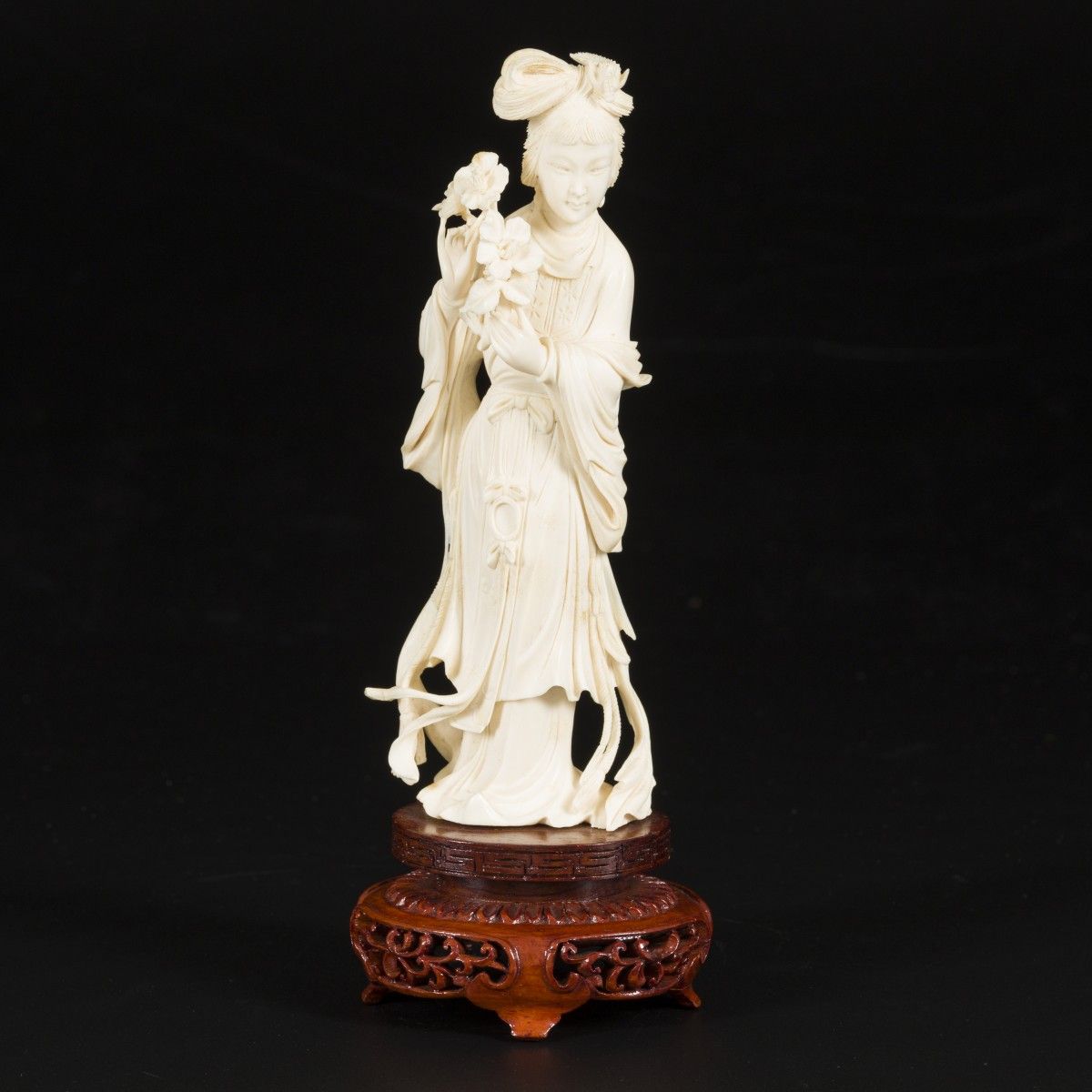 An ivory Guanyin on a wooden base, China, early 20th century. Abm. 21 x 7 cm. Sc&hellip;
