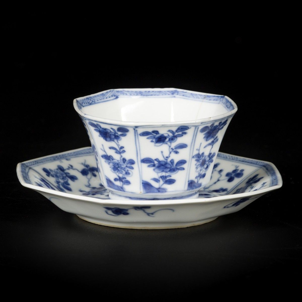A porcelain cup and saucer, angled model with floral decorations, China, Kangxi.&hellip;