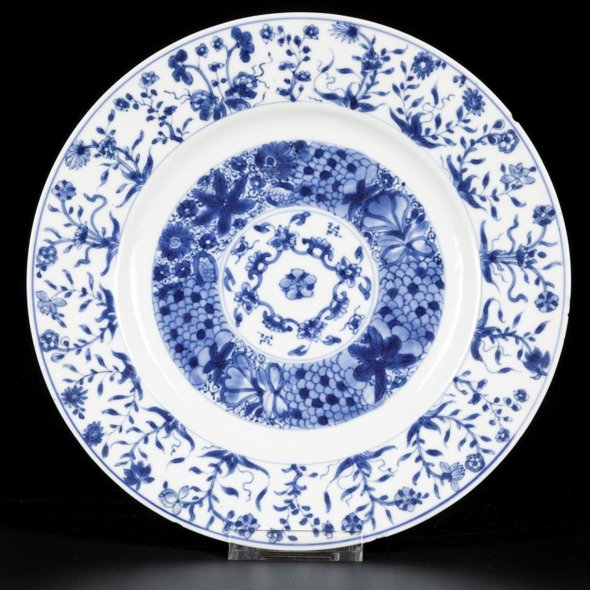 A porcelain charger with floral decoration, China, Kangxi. Diam. 24.5 cm. Chips &hellip;