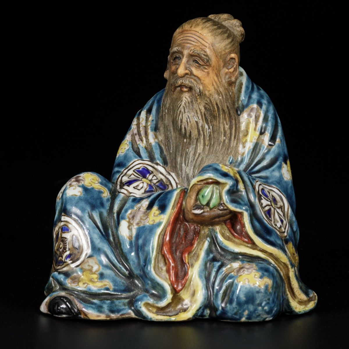 A sitting porcelain philosopher with a peach in his hand, China, 19/20th century&hellip;