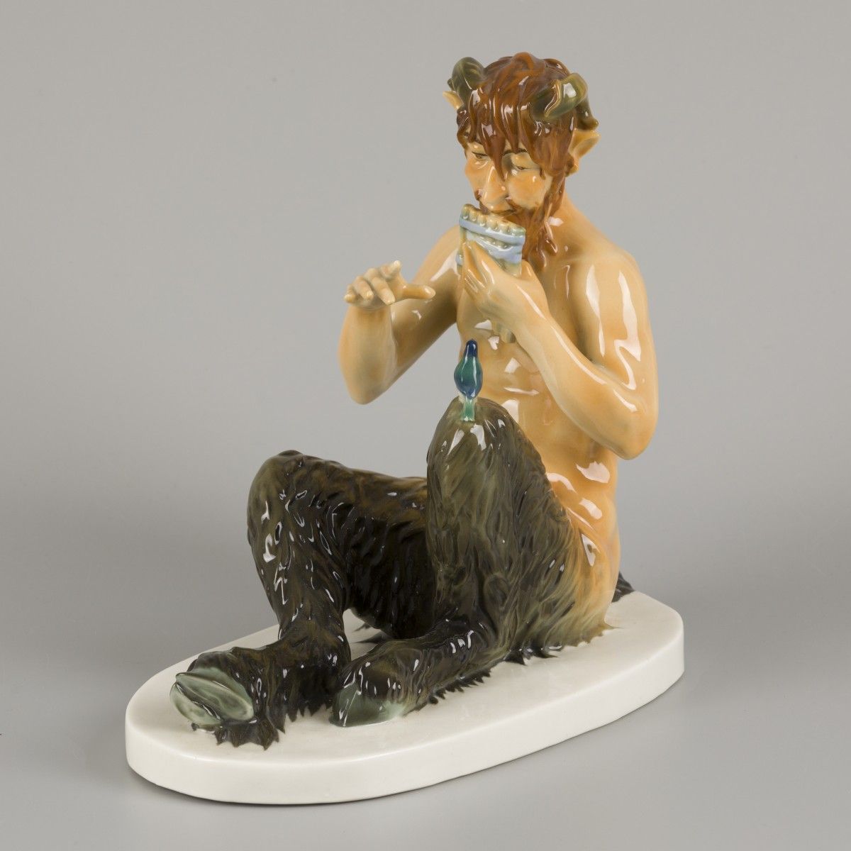 A polychromed porcelain statuette of a pan-flute playing faun, Germany, 2nd half&hellip;