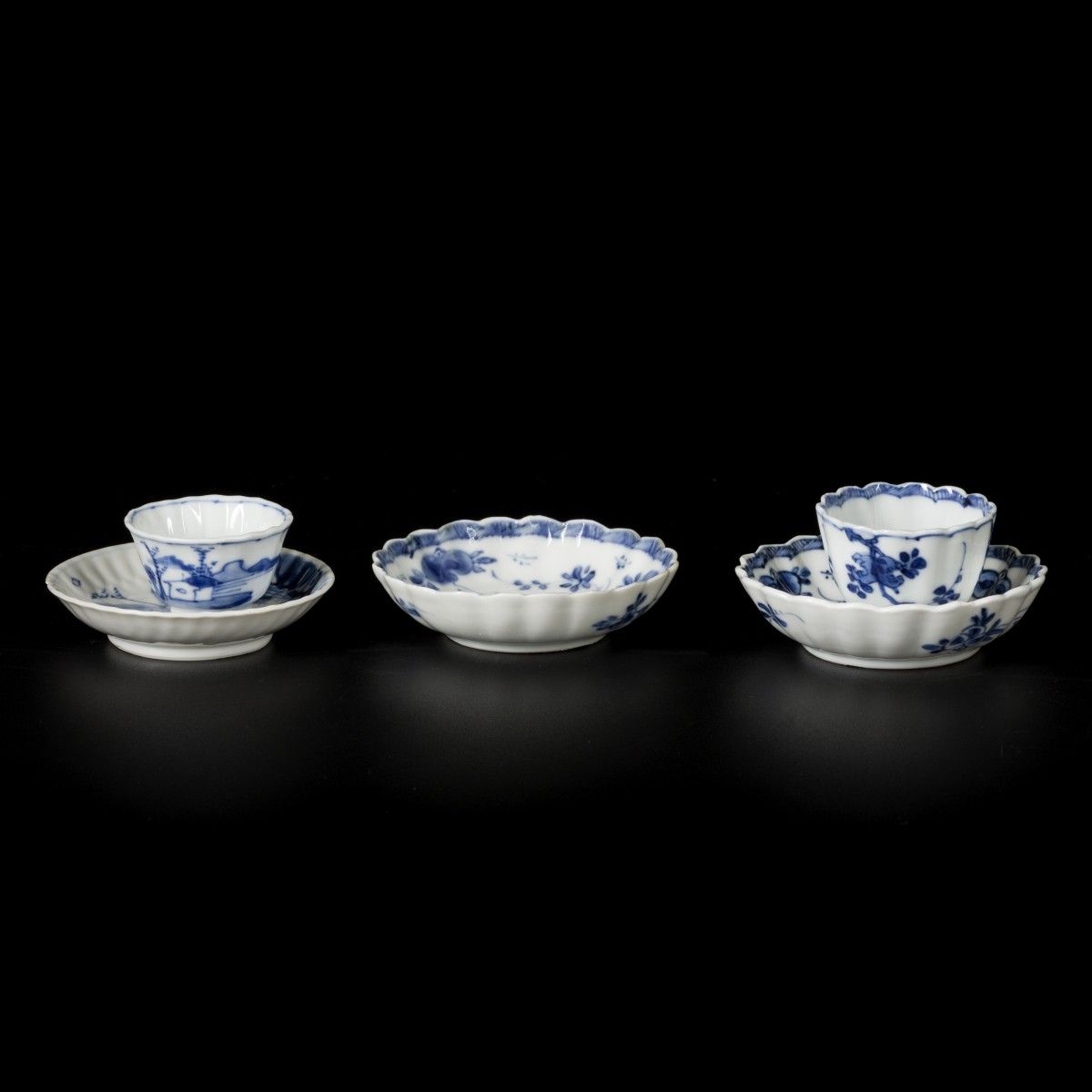 A lot comprised of (3) porcelain ribbed dishes and two cups with floral decorati&hellip;