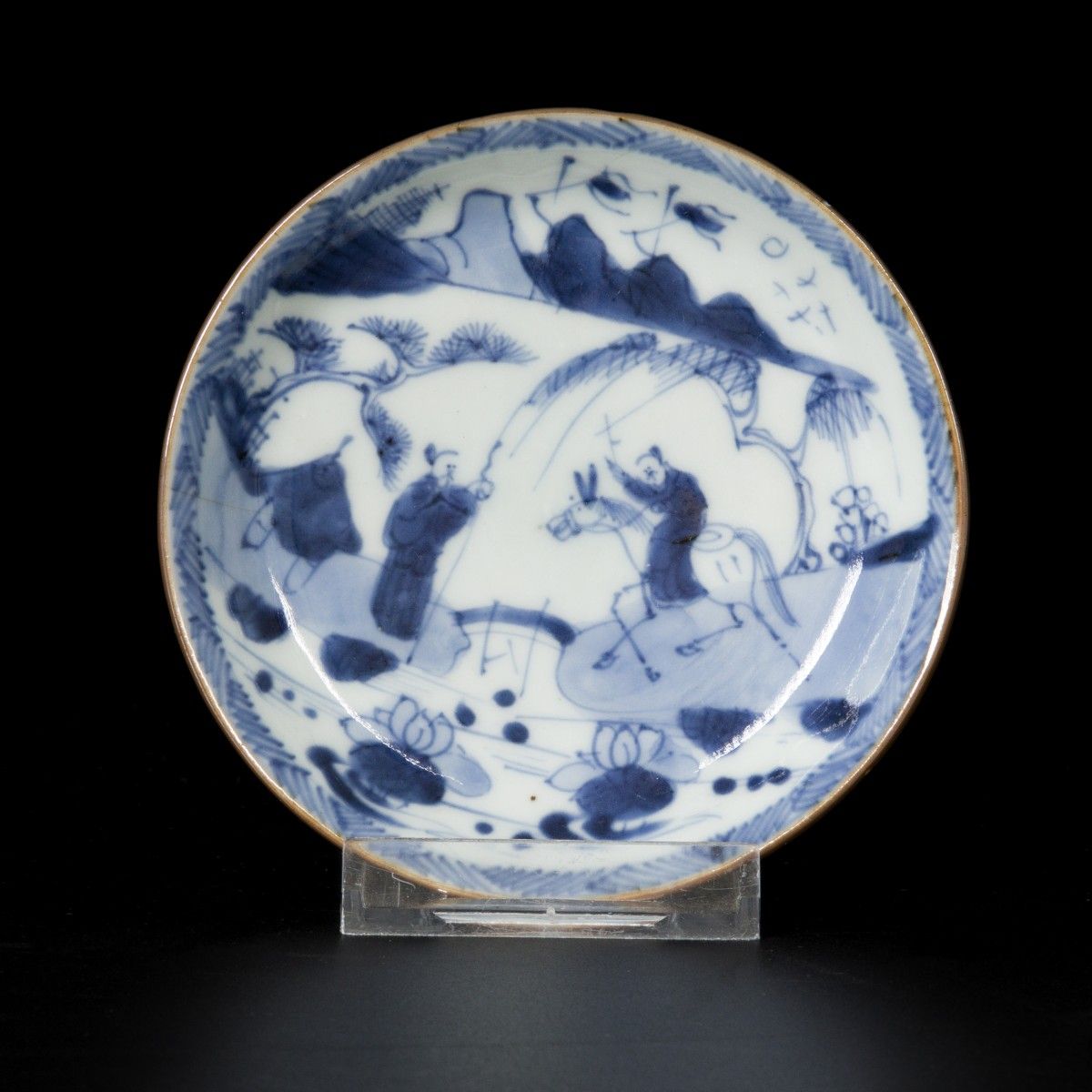 A porcelain plate decorated with figures in a landscape, China, 18th century. Du&hellip;