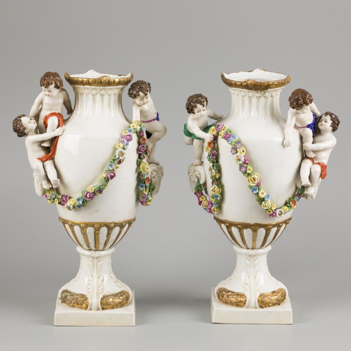 A set of (2) porcelain vases decorated with flowers, ram heads and children, Sit&hellip;