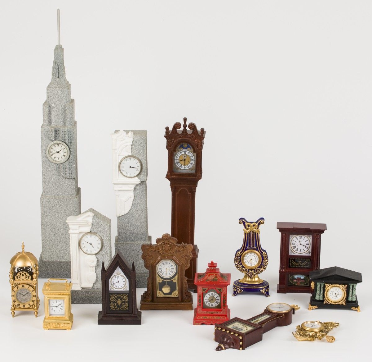 A lot consisting of miniature clocks in the shape of a standing watch and pendul&hellip;