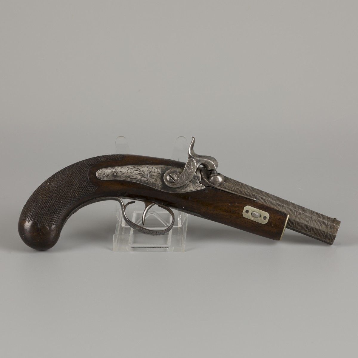 A 19th C. Percussion pistol with ciseled barrel. Ramrod missing.

Lenght overall&hellip;