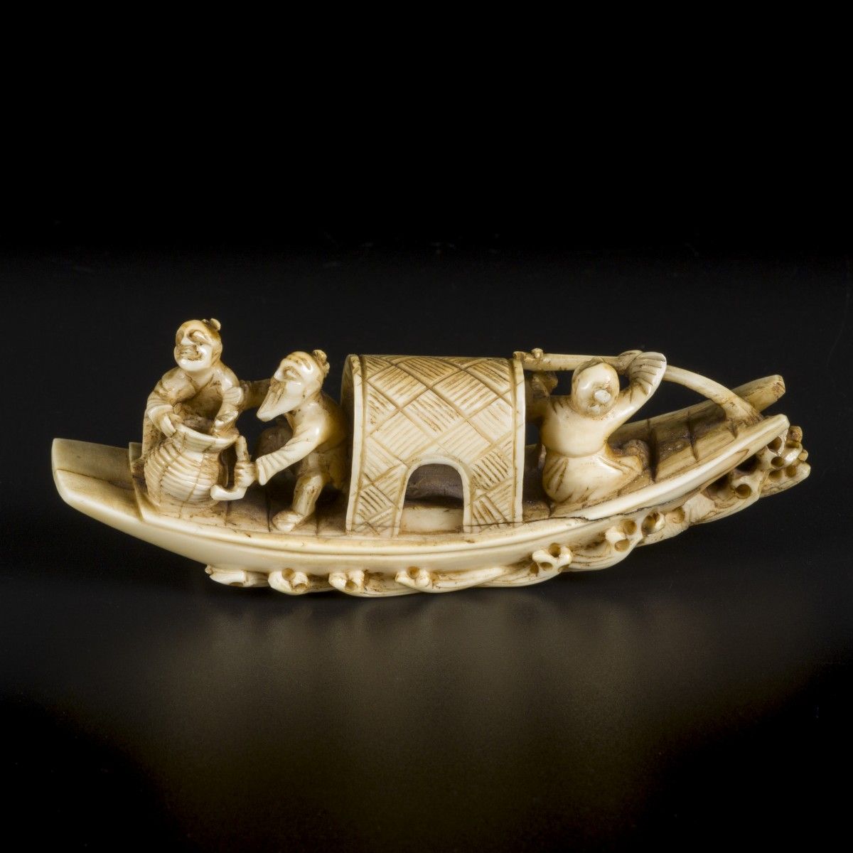 An ivory okimono of a gondola with figures on it. Japan, end of Meji period. Dim&hellip;