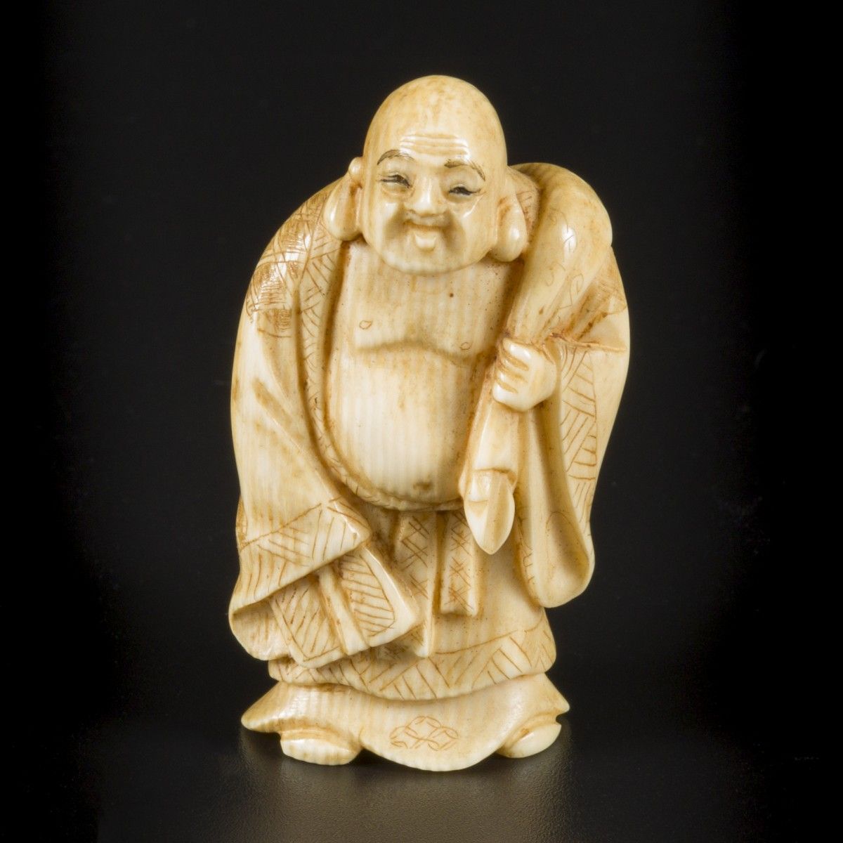 An ivory okimono of a laughing/ happy Buddha as traveller, Japan, Meiji period, &hellip;