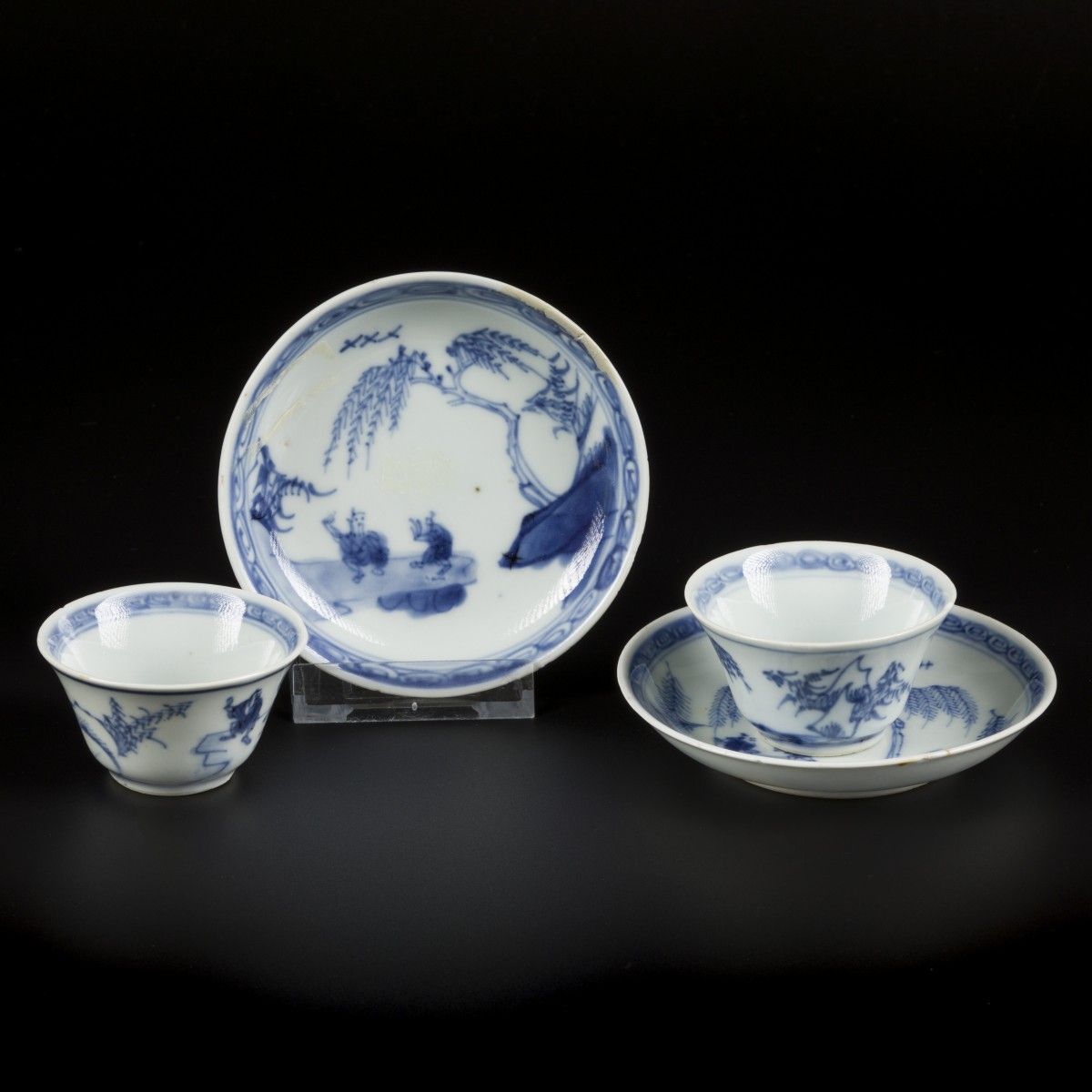 A set of (2) porcelain cups and saucers with decor figures in a landscape. China&hellip;