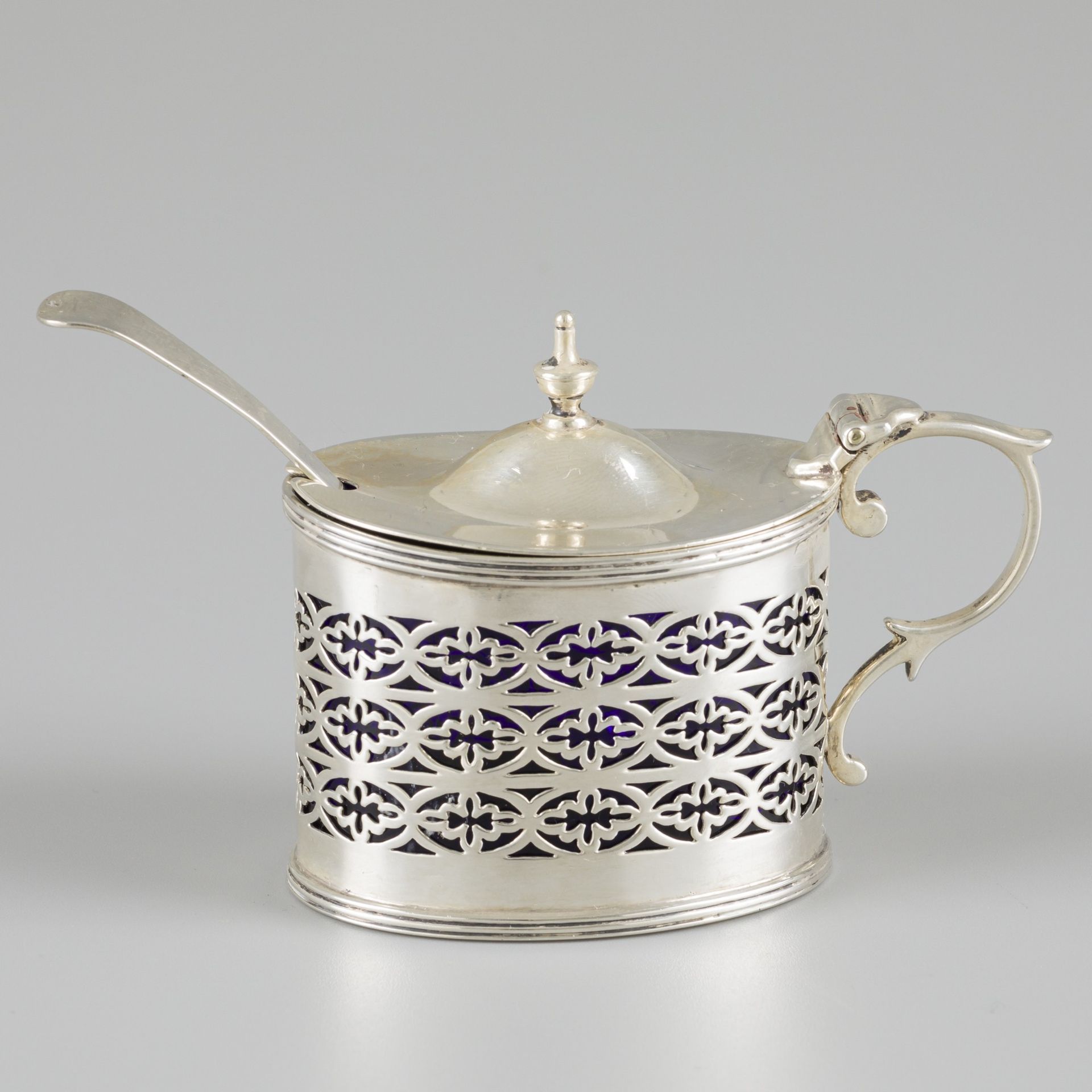 Mustard pot with spoon, silver. Oval model with hinged lid, edging and openwork &hellip;