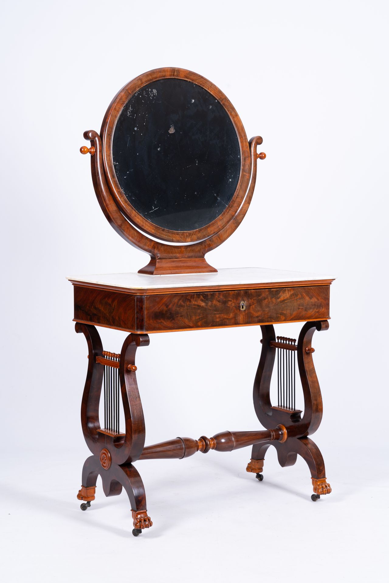 A mahogany toiletry table with lyre harp shaped base and marble top, 19th C. A m&hellip;