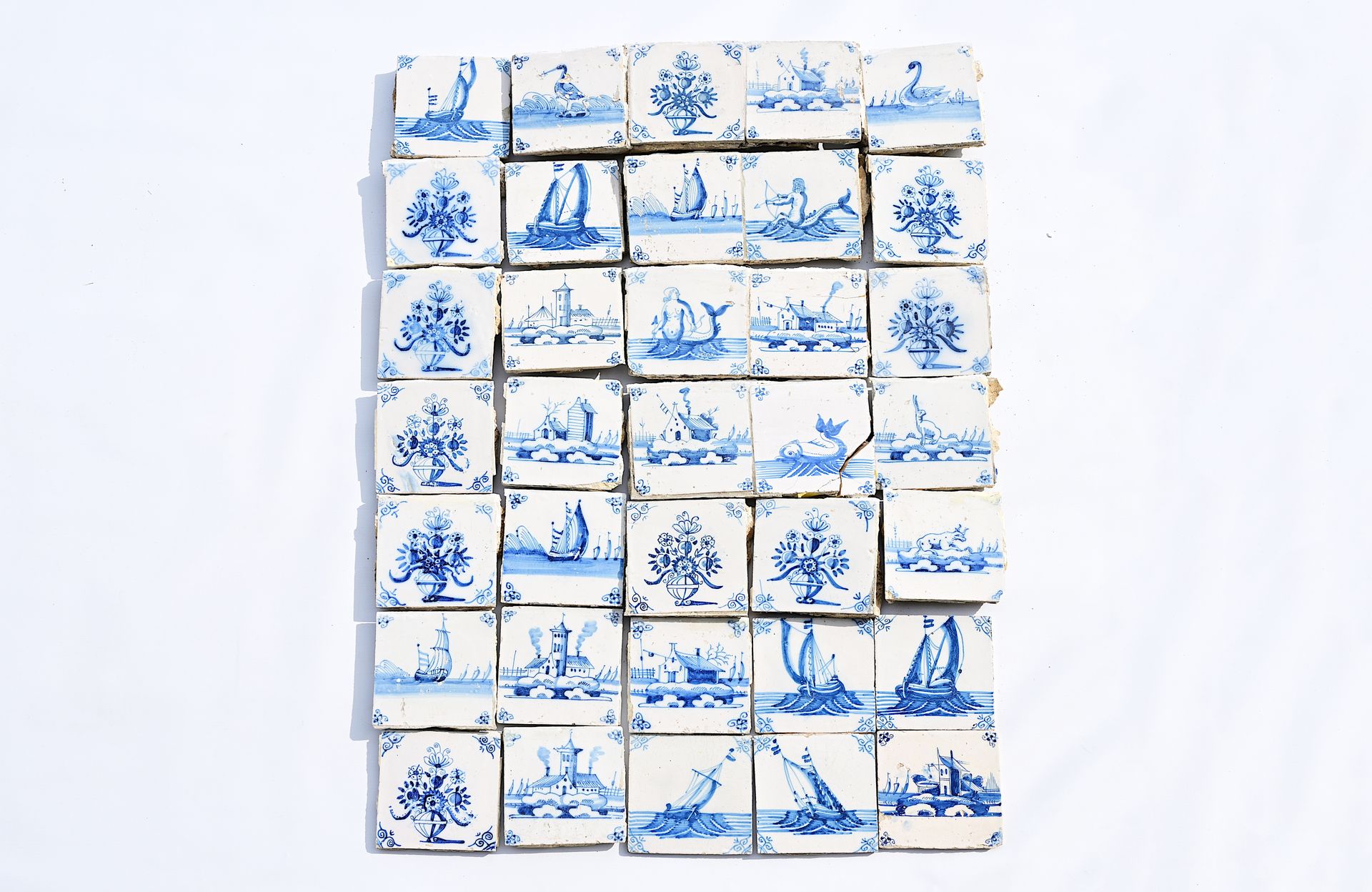 A varied collection of Dutch Delft blue and white tiles with flowers, boats, ani&hellip;